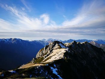 Scenic view of snowcapped mountain against blue sky