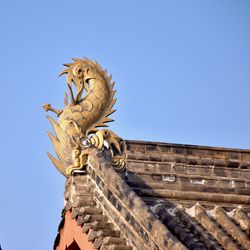 Low angle view of statue against sky