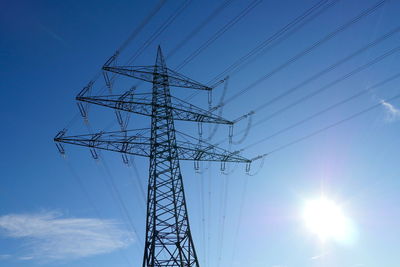 Low angle view of electricity pylon against sky