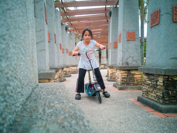 Full length portrait of girl riding bicycle