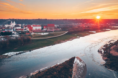 Scenic view of river against sky during sunset