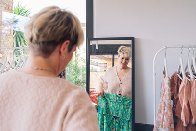 Rear view of woman standing against wall