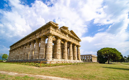 Low angle view of historical building against clear blue sky  , temple of paestum. italy