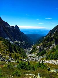 Scenic view of mountains against blue sky