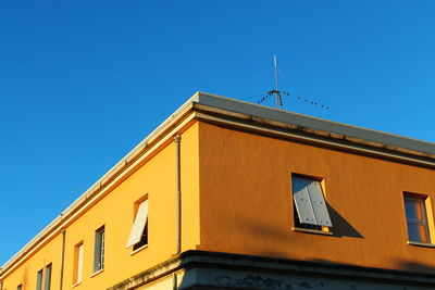 Low angle view of building against clear blue sky