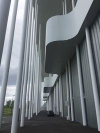 Low angle view of empty walkway amidst buildings