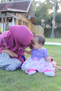 Woman with baby girl at yard