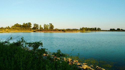 Scenic view of lake at maumee bay state park against sky during sunset