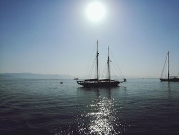 Sailboat sailing on sea against clear sky