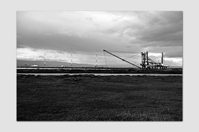 Crane on field against sky