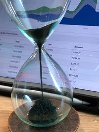 Close-up of clock on glass table