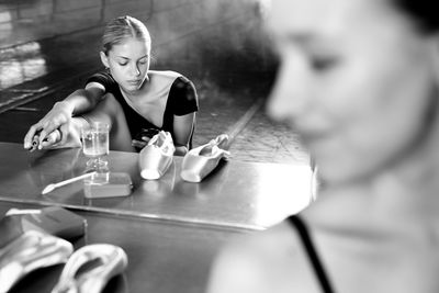 Close-up of young woman drinking water