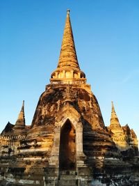 Low angle view of stupa at wat phra sri sanphet against clear blue sky