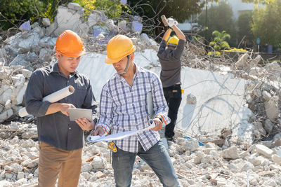 Low angle view of men working at construction site