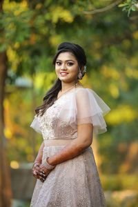 Portrait of a smiling young woman standing outdoors