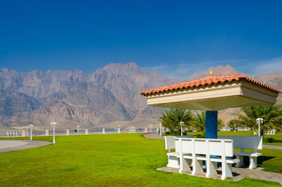 Built structure on landscape against blue sky