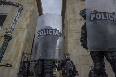 Low angle view of police force with shields on street