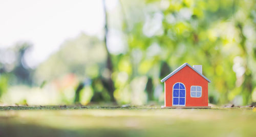 Close-up of small toy in house against building