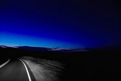 Country road leading towards mountains