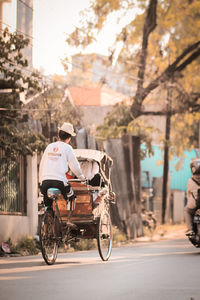 Man riding bicycle on street in city