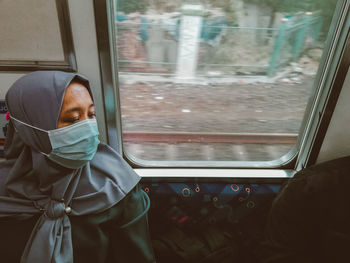 Man looking through train window