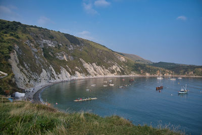 Scenic view of sea and mountains against sky