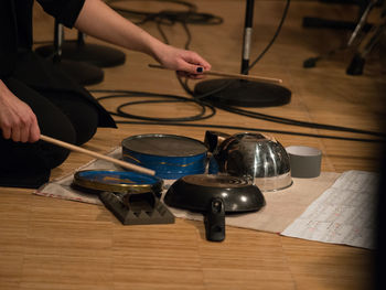 Midsection of woman playing music with kitchen utensils