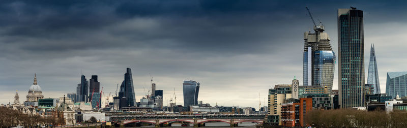 View of skyscrapers against cloudy sky