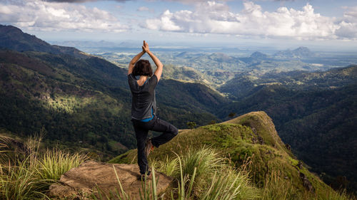 Rear view of woman standing on mountain