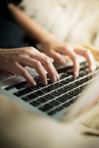 Close-up of woman using laptop in home