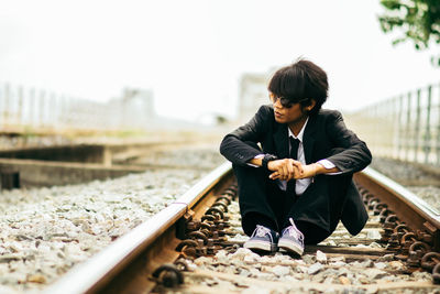 Full length of man skateboarding on railroad track