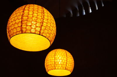 Low angle view of illuminated pendant lights