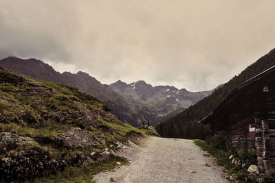 Road amidst mountains against sky