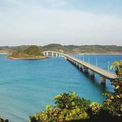 Bridge over sea against sky