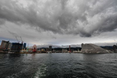 View of buildings in city against cloudy sky