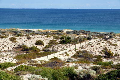 High angle view of sea against clear blue sky