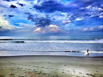 Man standing on beach against sky