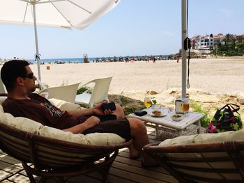 Rear view of man sitting on bench