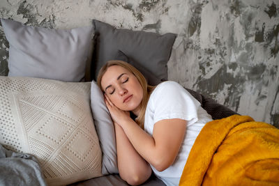 Portrait of young woman sitting on bed