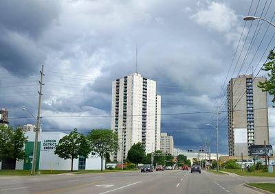 Road by city against sky