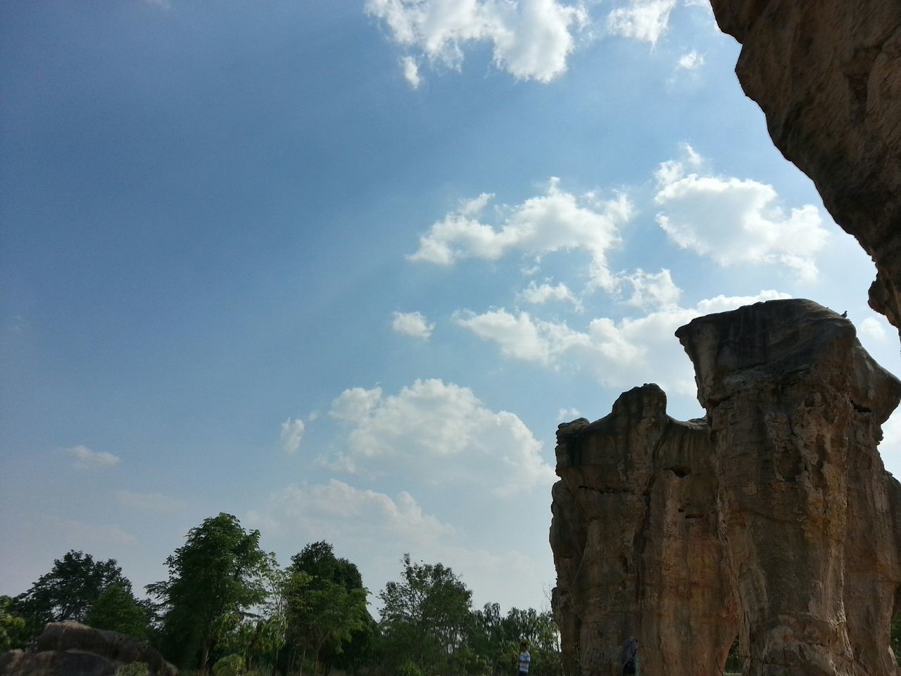 sky, low angle view, tree, tranquility, rock formation, tranquil scene, scenics, beauty in nature, nature, rock - object, cloud - sky, cloud, mountain, cliff, rocky mountains, day, non-urban scene, idyllic, geology, outdoors