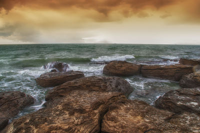 Scenic view of sea against cloudy sky