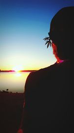 Silhouette woman against clear sky during sunset