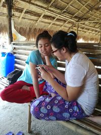 Happy friends sitting on floor