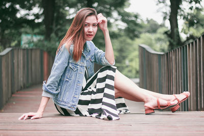 Portrait of young woman sitting outdoors