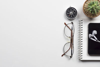 Directly above shot of pencils on table against white background