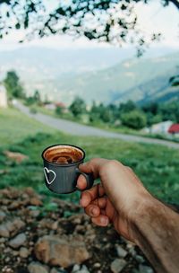 Hand holding coffee cup