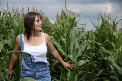 Young woman standing on grassy field