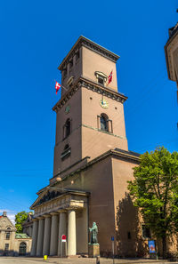 Low angle view of clock tower against sky