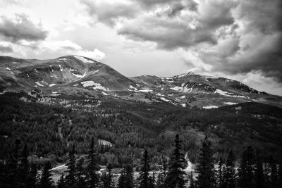 Scenic view of mountains against cloudy sky